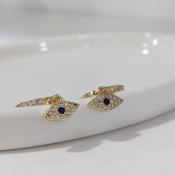 ARETES HUGGIE CON OJOS Y ZIRCONIA